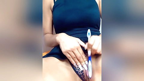 Indian girl with a nice face and mouth sucking a toy