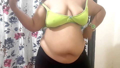 Amateur brunette in a red dress is playing with her tits