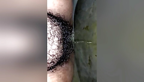 Pissing on hairy pussy in amateur homemade sex video