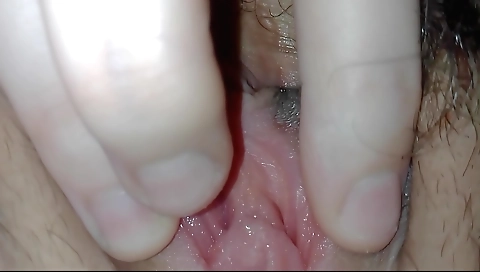 Sweet brunette with a hairy pussy enjoys fingering