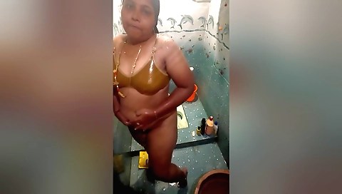 Indian slut with a natural body showering in the bathroom